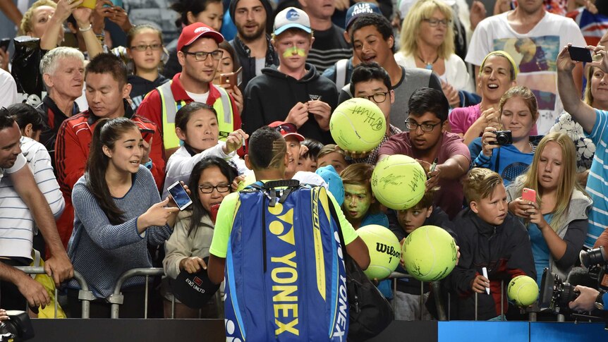 Kyrgios signs autographs after beating Seppi