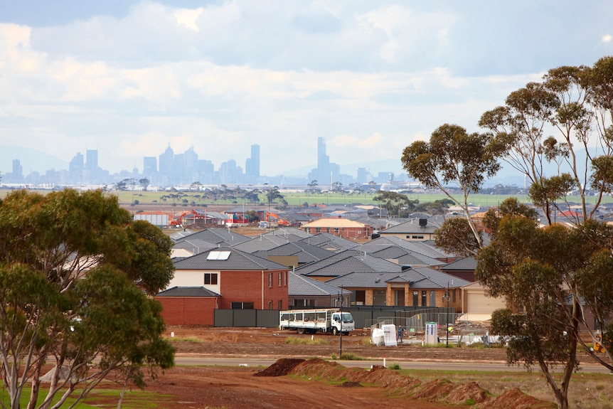 A suburb in Wyndham with many new houses being built, and Melbourne city skyscrapers in the distance.