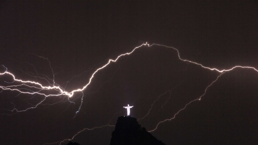 Lightning flashes over the Christ the Redeemer statue on top of Corcovado Hill.