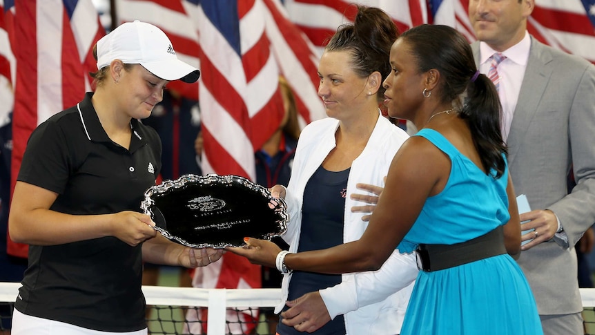 Casey Dellacqua and Ashleigh Barty receive their runners-up trophy at the US Open.