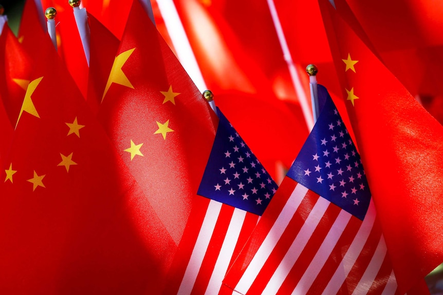 American flags are displayed together with Chinese flags on top of a trishaw in Beijing.