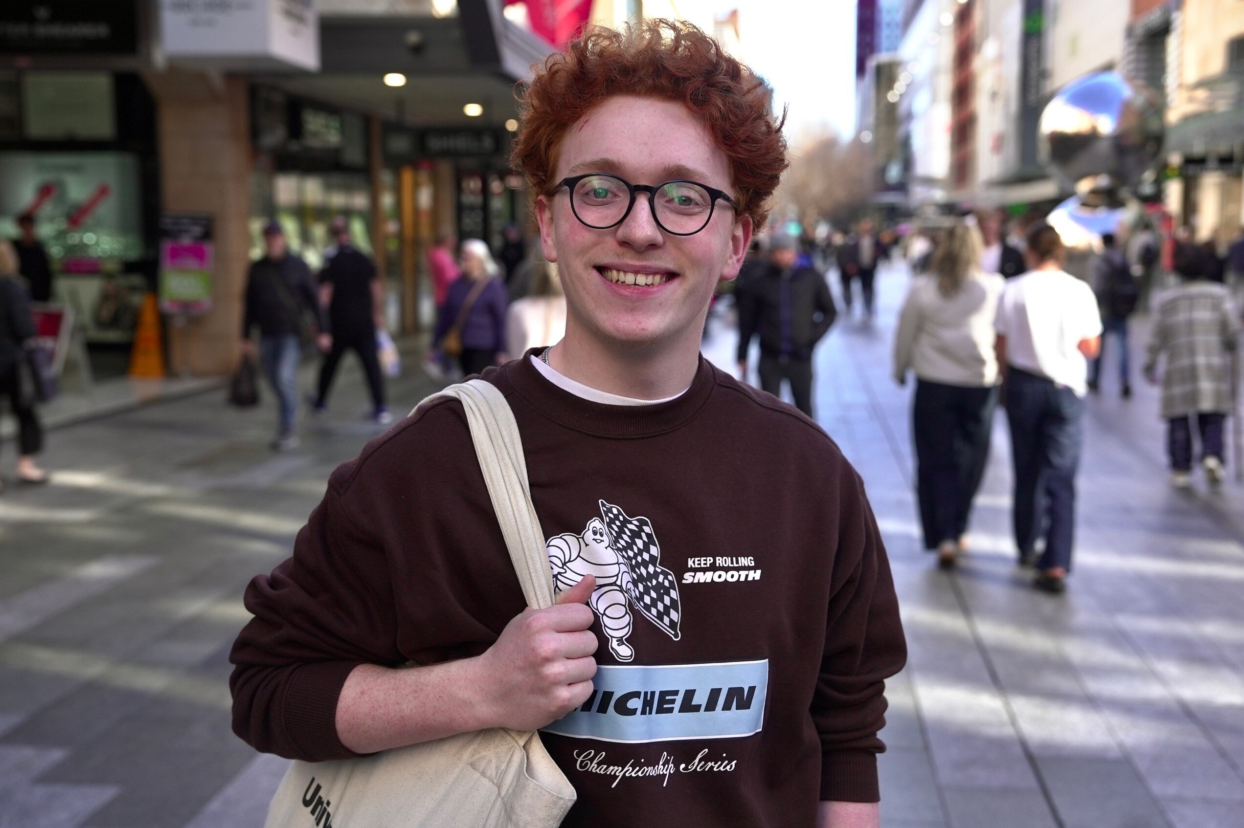 A young man with glasses and red hair.