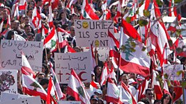 Thousands of people gather in central Beirut for a large anti-Syrian protest.