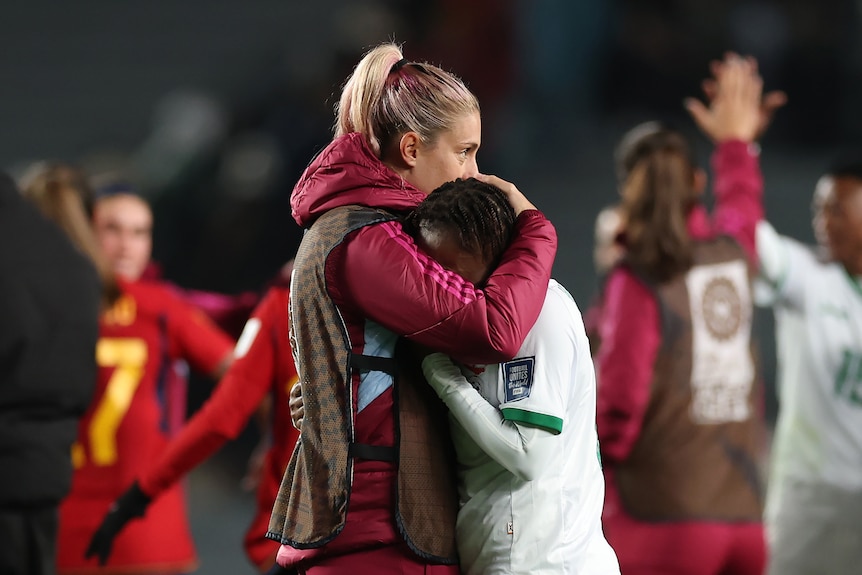 Mary Wilombe of Zambia is hugged by Alexia Putellas