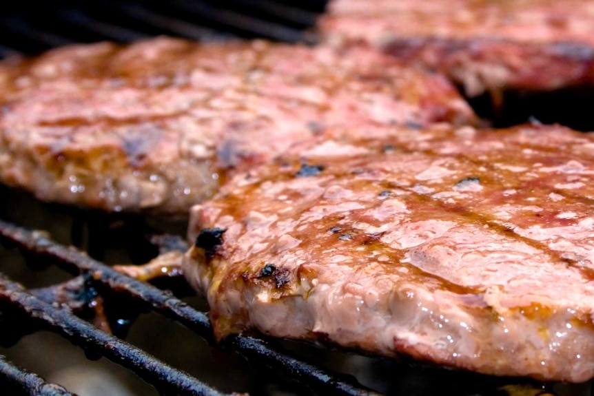 Steaks on a barbeque. A senate inquiry into the red meat industry has delivered an interim report.