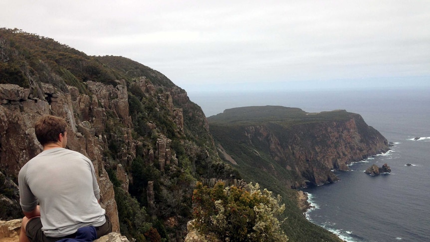 A bushwalker takes a break on the Cape Raoul Walking track in south-east Tasmania.