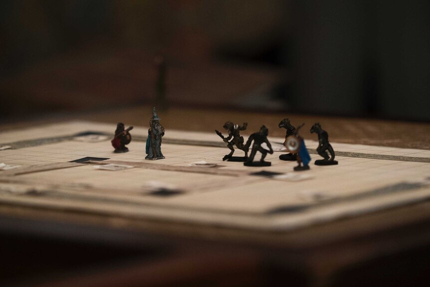 A scene from the TV series Stranger Things with a bunch of fantastical Dungeons & Dragons figurines on a map