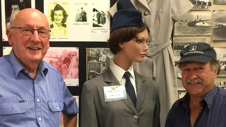 Bill Sharp and Jim Ford with one of the old Ansett hostess uniforms at the Sir Reginald Ansett Transport Museum in Hamilton