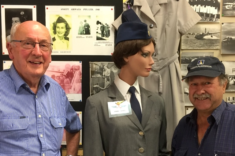 Bill Sharp and Jim Ford with one of the old Ansett hostess uniforms at the Sir Reginald Ansett Transport Museum in Hamilton