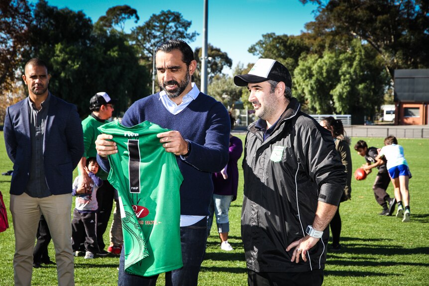 Adam Goodes presented with the Kangaroo Flat football jumper worn in the local reconciliation match.