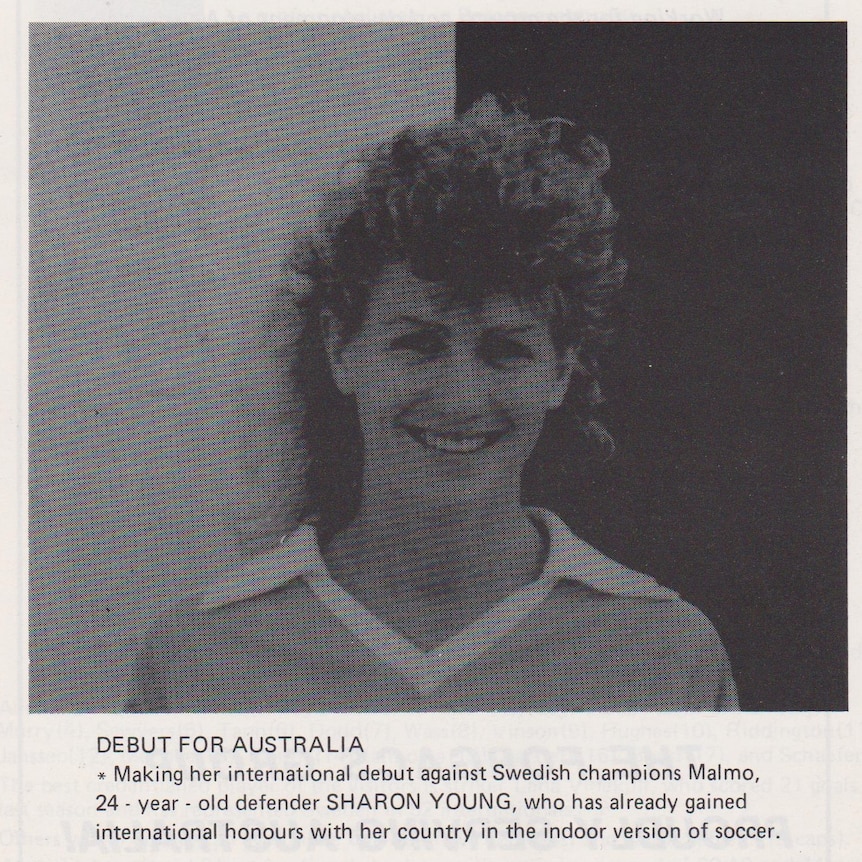 A black and white photo of a woman with big curly hair in a newspaper