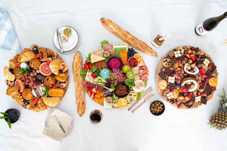 Platters of bright food sit on a large table