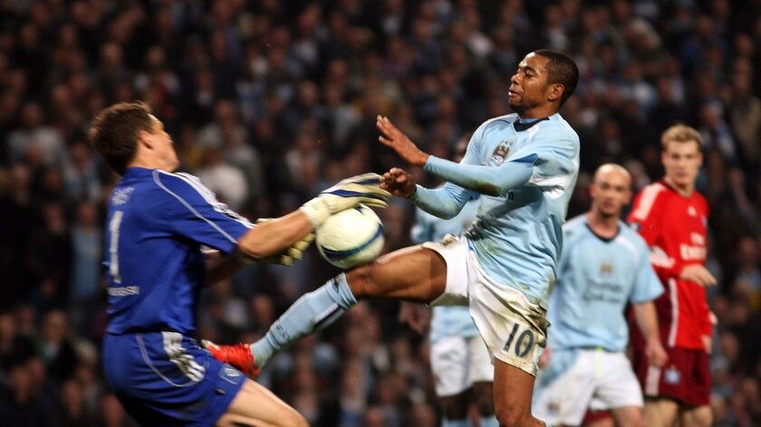 Manchester City's Robinho, right, collides with Hamburg's Frank Rost
