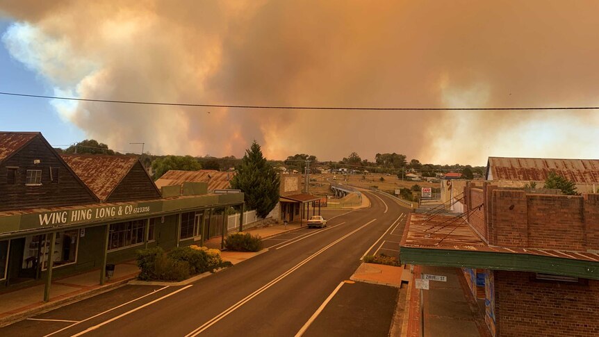 rural town with smoke in the bushlands in the horizon blanketing the sky