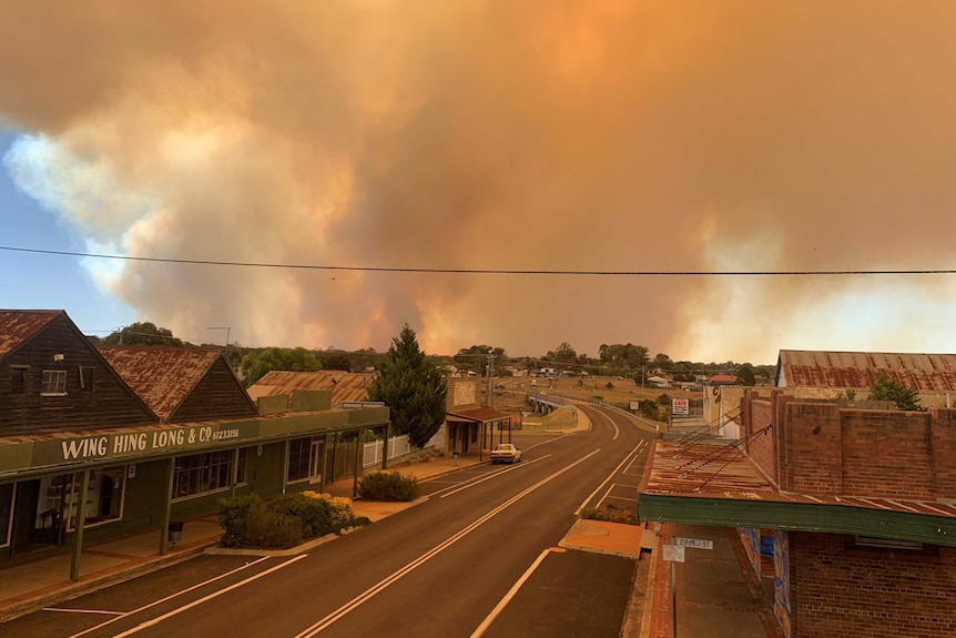 rural town with smoke in the bushlands in the horizon blanketing the sky