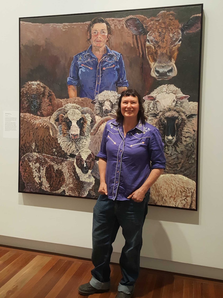 Lucy Culliton stands before one her painting at the National Portrait Gallery in Canberra.