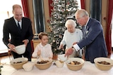 Queen Elizabeth, Prince Charles, Prince William and Prince George work together to prepare Christmas pudding mixture.