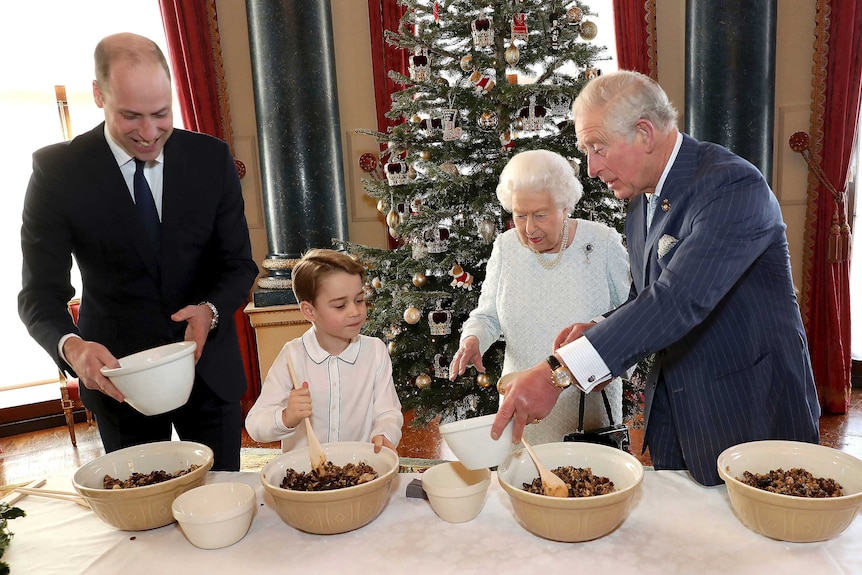 Queen Elizabeth, Prince Charles, Prince William and Prince George work together to prepare Christmas pudding mixture.