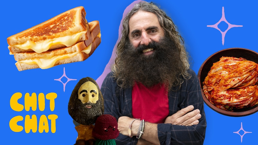 Costa, who has long hair and a bushy beard, smiles against a blue backdrop, with images of a cheese toastie and kimchi.