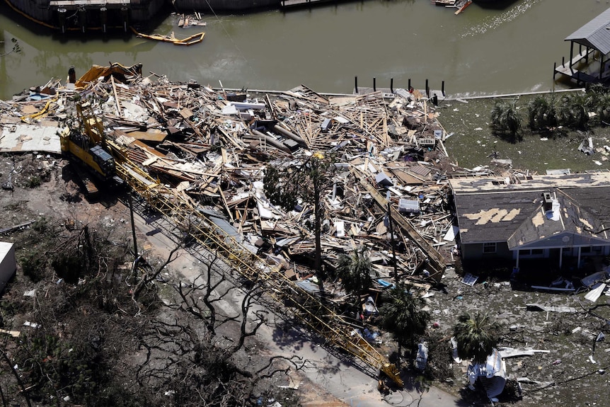 Debris from Hurricane Michael piled up on edge of water