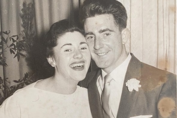 An old, black and white photo of a happy couple.