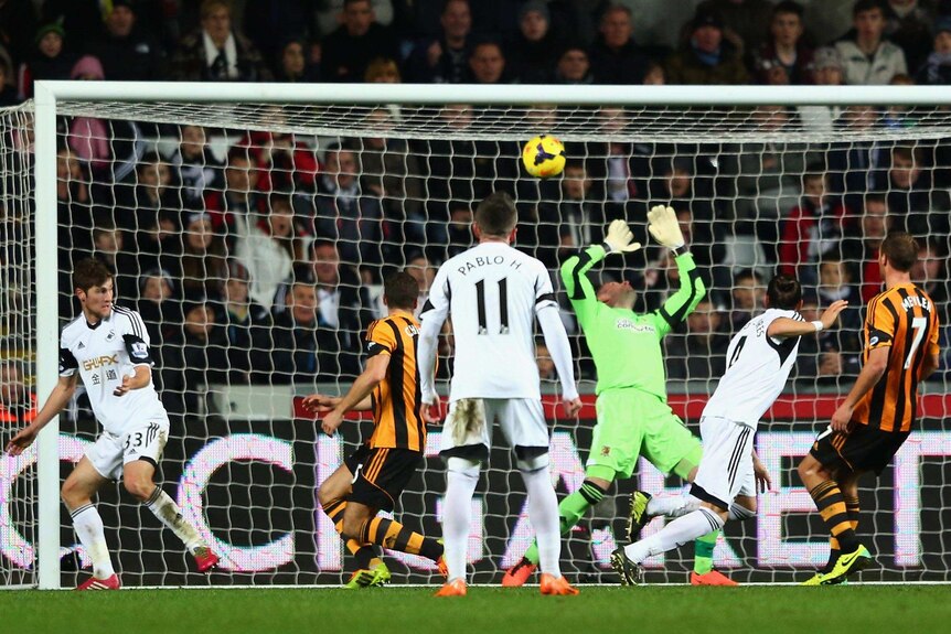 Chico Flores (2R) of Swansea City scores his side's equalising goal against Hull City.
