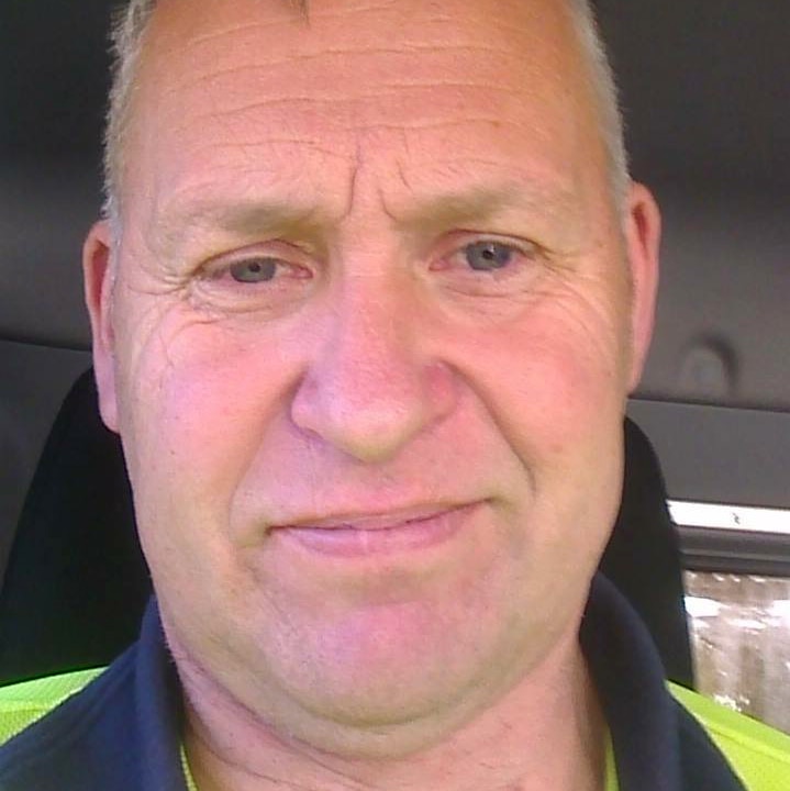 A tight head shot of Stephen Illing sitting in a truck wearing a yellow hi-vis shirt.