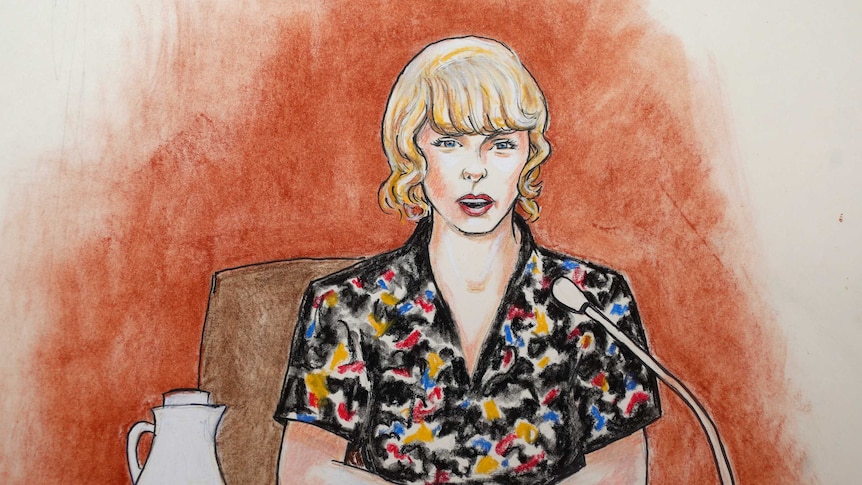 A court sketch of Taylor Swift. She is shown sitting at a witness stand, wearing a black top with spots of primary colours.