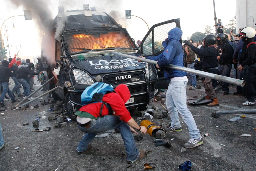 Protesters in Rome destroy a Carabinieri paramilitary police vehicle, October 15, 2011.