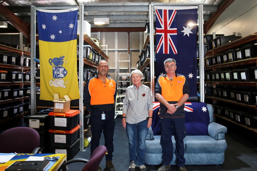 Curious Canberran Faye Powell with Michael Ariolie and Marc Hirzel of the ACT flag store.
