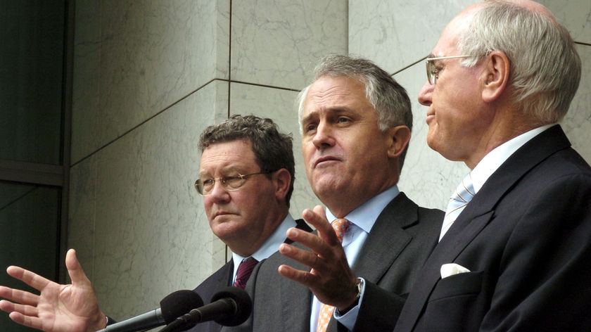 Alexander Downer (L) says party members have considered a leadership change but are now backing John Howard (R) (File photo).