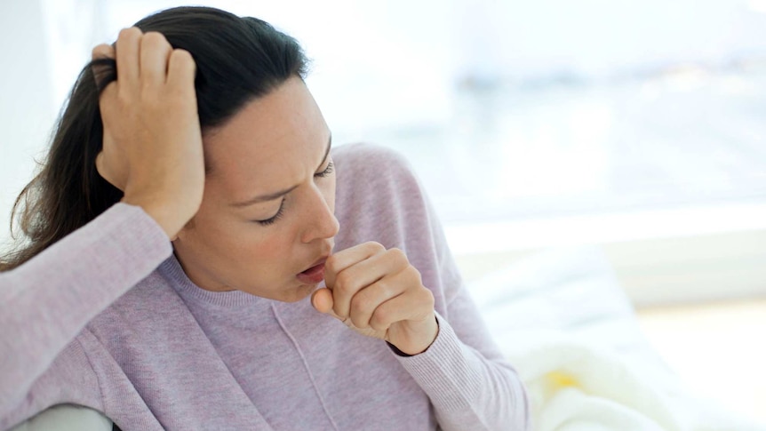 Young woman coughing.