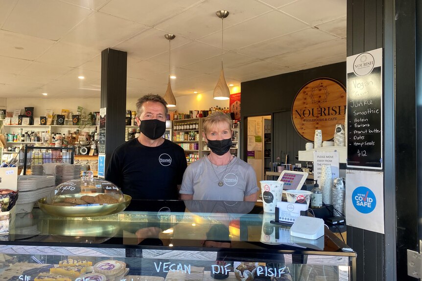 Owners standing in their cafe at Merimbula