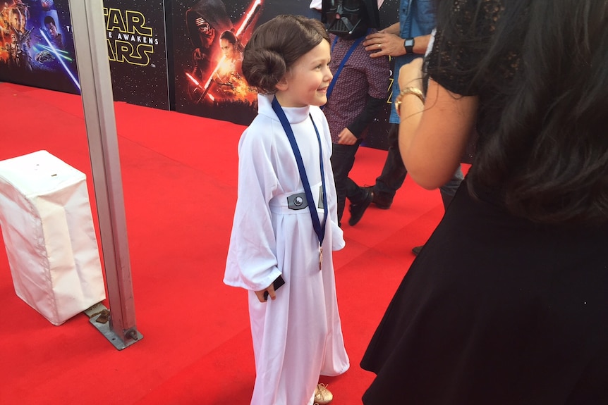 A young Star Wars fan dressed as Princess Leia.