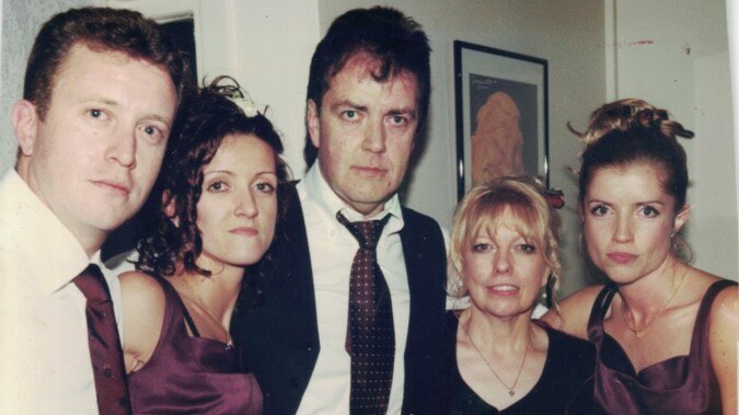 The Hodson family in an old photograph, in formal wear. Terrance and Christine are surrounded by two daughters and one son.