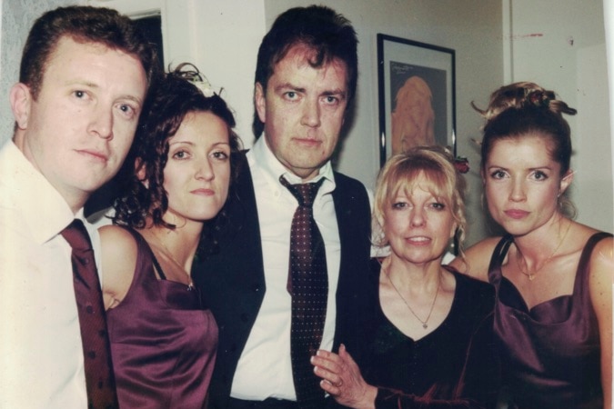 The Hodson family in an old photograph, in formal wear. Terence and Christine are surrounded by two daughters and one son.