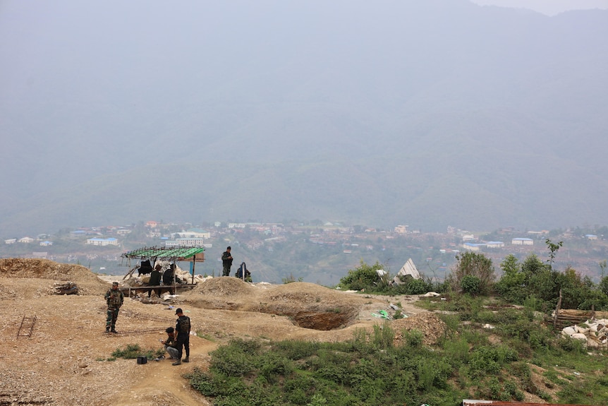 A hill where soldiers are gathering.