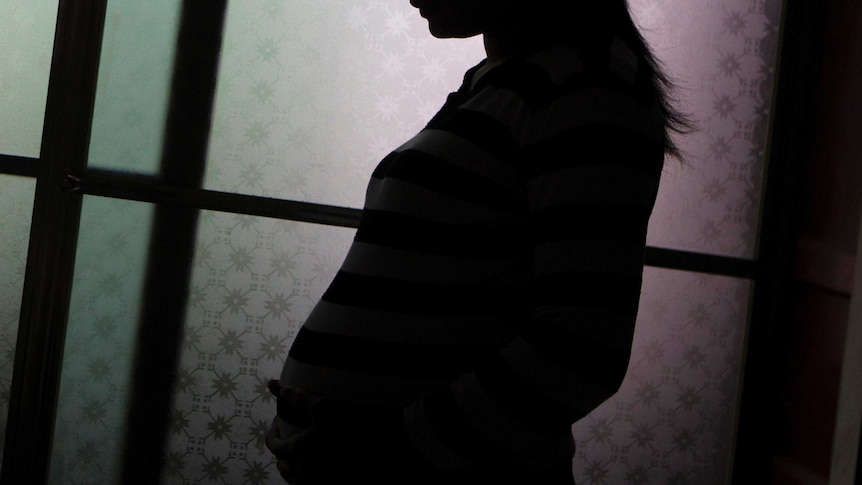 A silhouette of a pregnant woman.