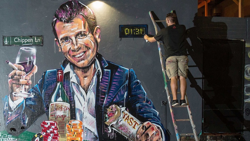 NSW Premier Mike Baird is seen in a mural with a pile of casino chops and a glass of wine.