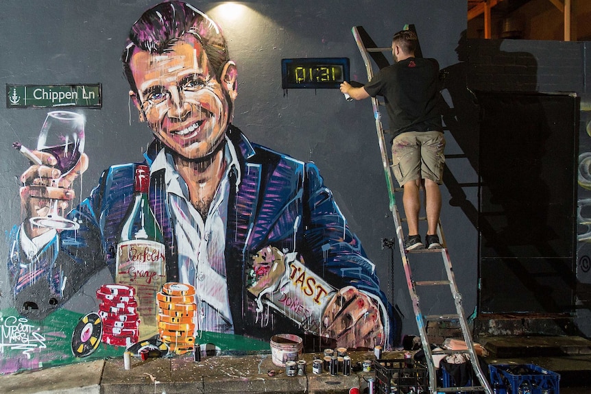 NSW Premier Mike Baird is seen in a mural with a pile of casino chops and a glass of wine.