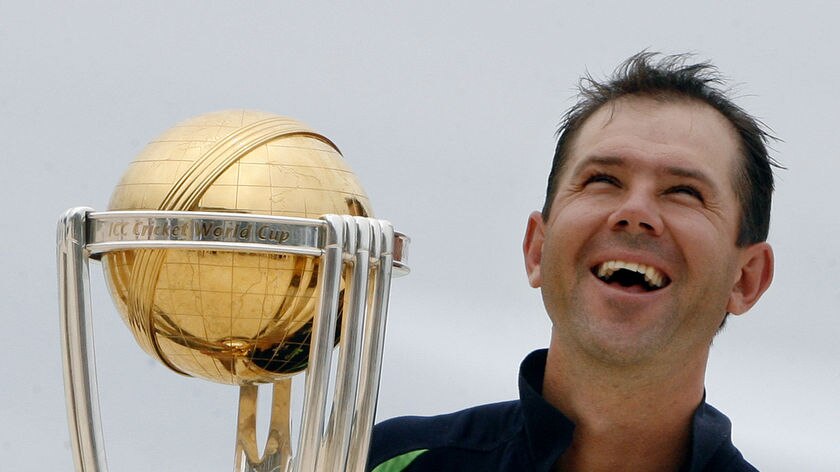 Ricky Ponting poses for photographers on the beach with the Cricket World Cup trophy.