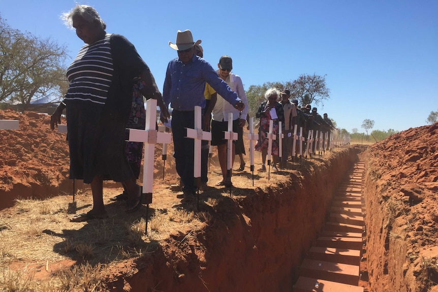 The Fitzroy Crossing community gather to re-bury the remains of their relatives