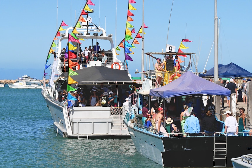 A line-up of decorated boats in a harbour