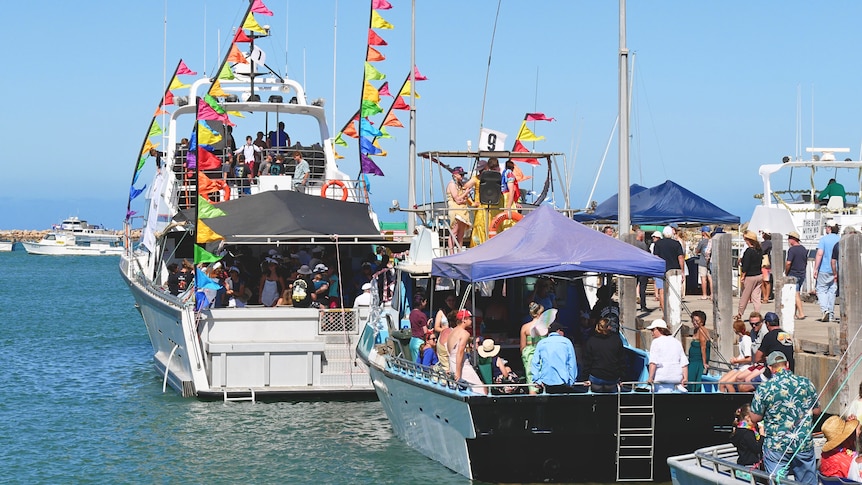 A line-up of decorated boats in a harbour