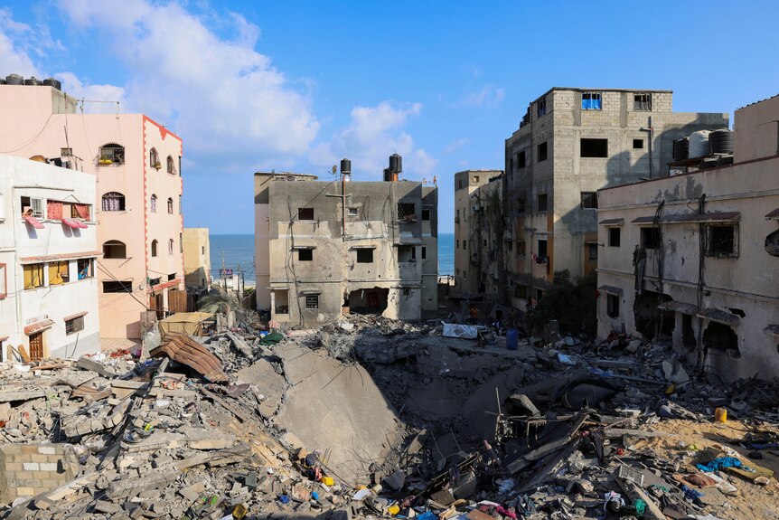 Large crater left where homes used to stand after Israeli air strikes in the Gaza Strip.