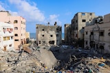 Large crater left where homes used to stand after Israeli air strikes in the Gaza Strip.