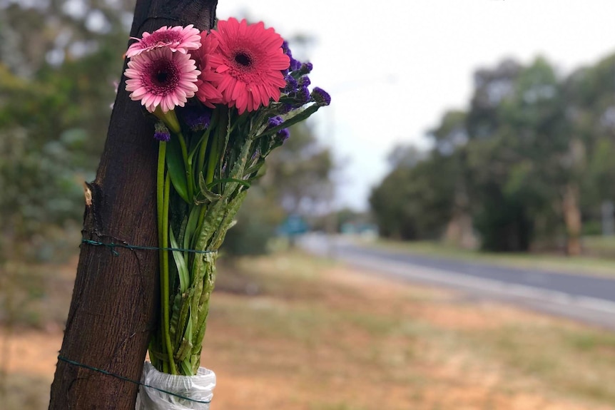 Flowers tied to a tree on Belconnen Way