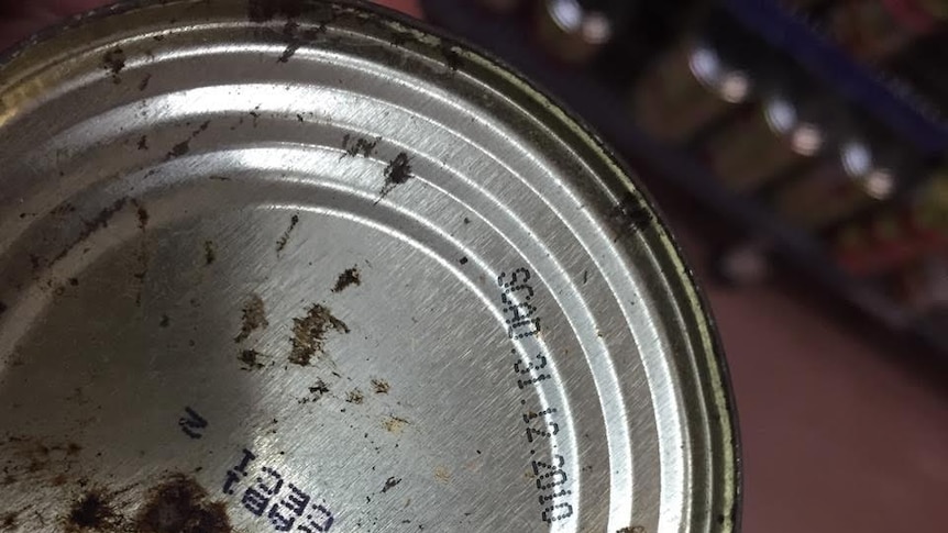 A rusty can of food with an expiry date of 2010