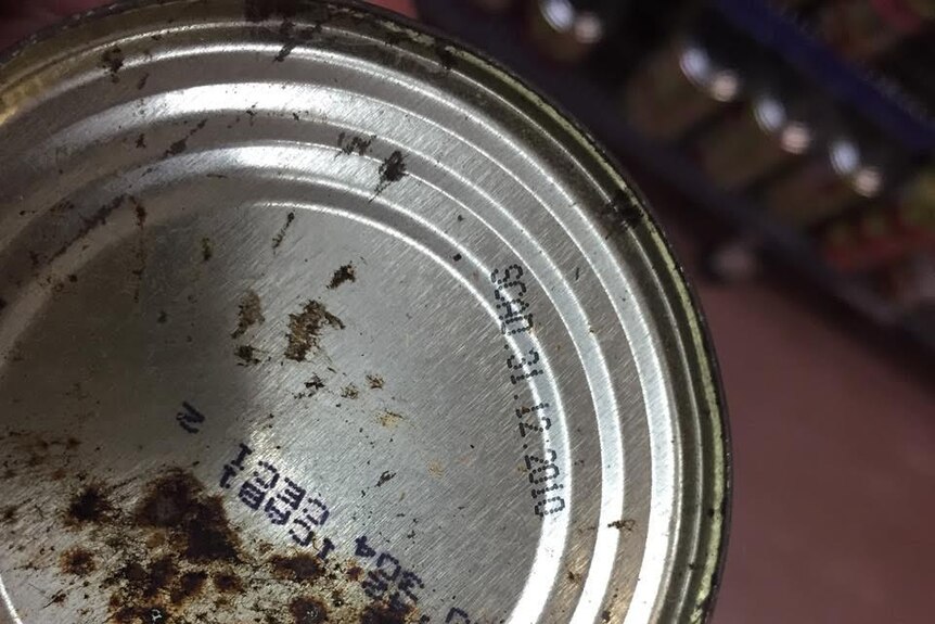 A rusty can of food with an expiry date of 2010