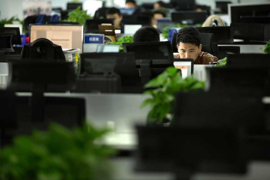 A Watrix employee works at his desk in their company's offices in Beijing.